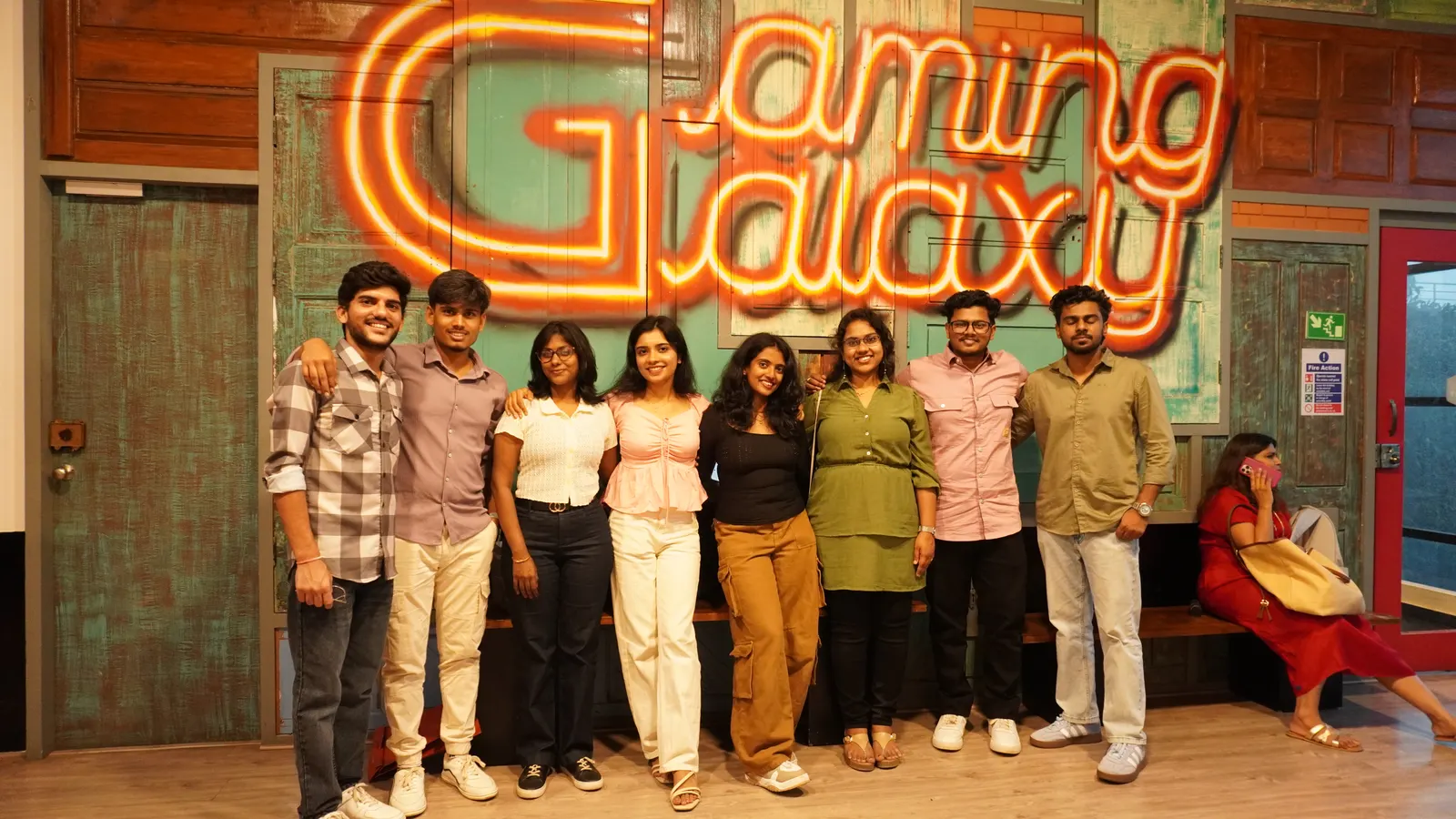 Group photo in front of the Gamingalaxy neon venue sign in Whitefield Bengaluru