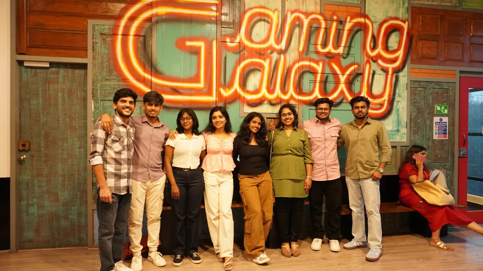 Group photo in front of the Gamingalaxy neon venue sign in Whitefield Bengaluru