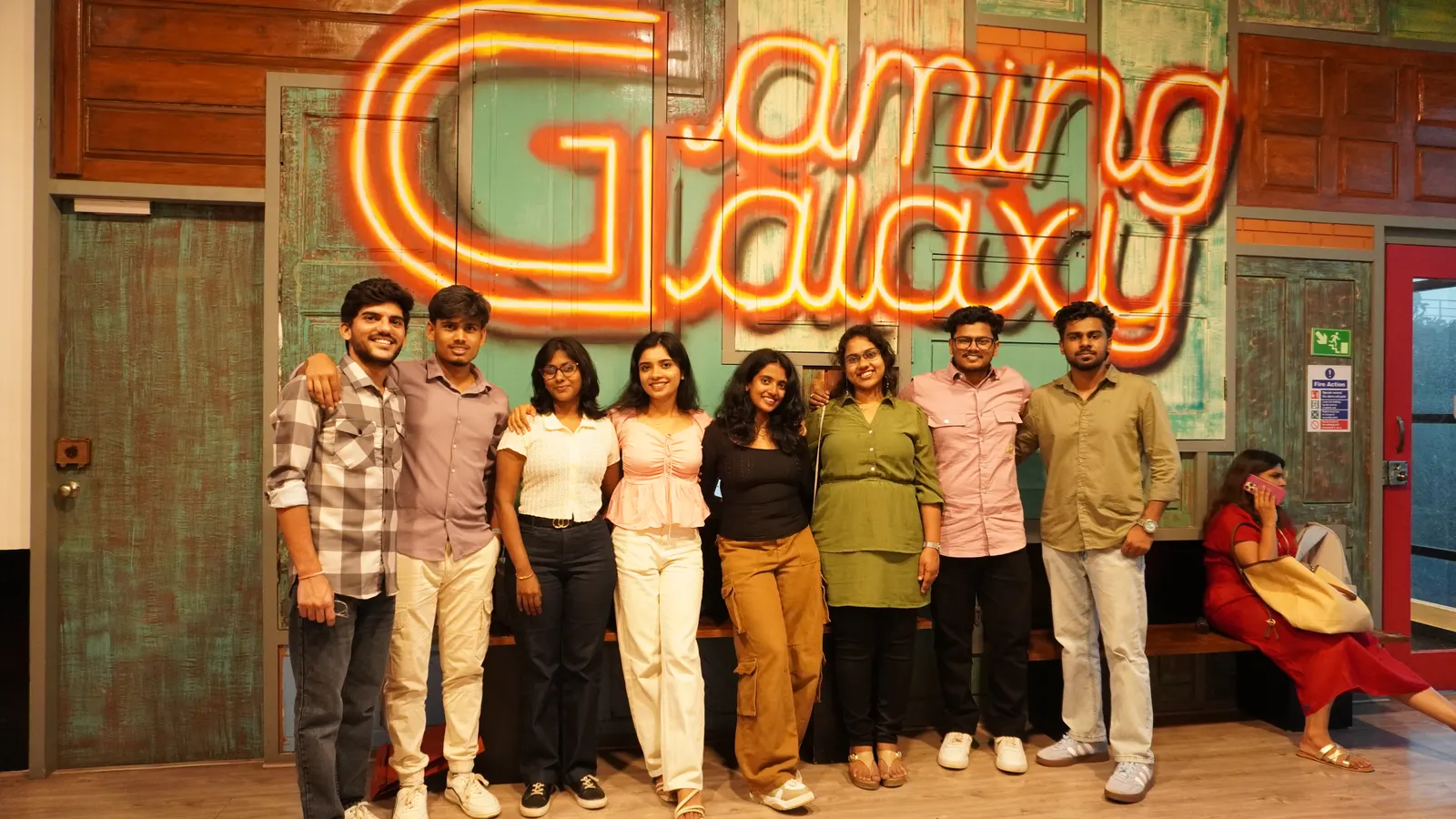 Group photo in front of the Gamingalaxy neon venue sign in Whitefield Bengaluru
