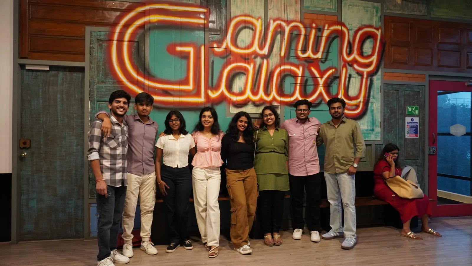 Group photo in front of the Gamingalaxy neon venue sign in Whitefield Bengaluru