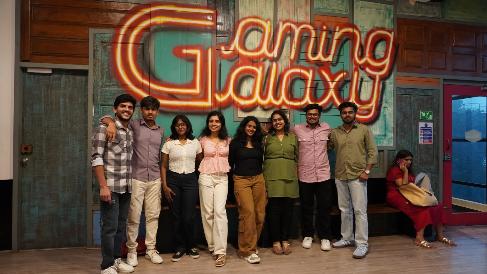 Group photo in front of the Gamingalaxy neon venue sign in Whitefield Bengaluru