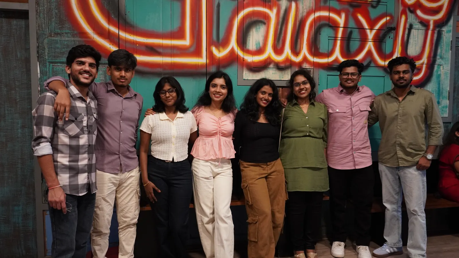 Group photo in front of the Gamingalaxy neon venue sign in Whitefield Bengaluru