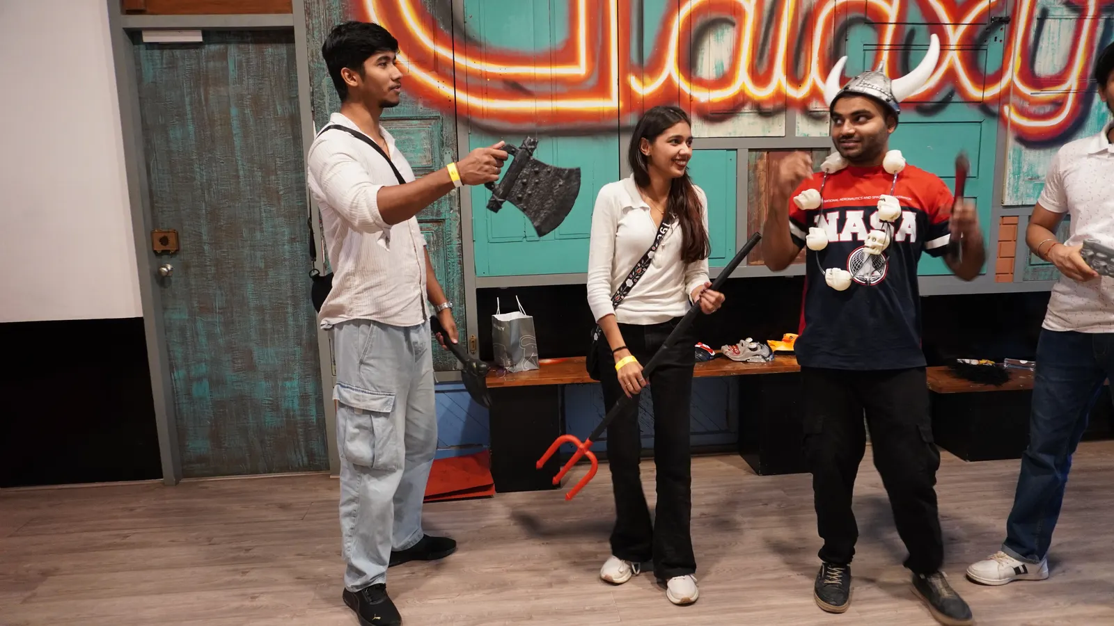 Guests enjoying action game props and indoor activities at Gamingalaxy Whitefield