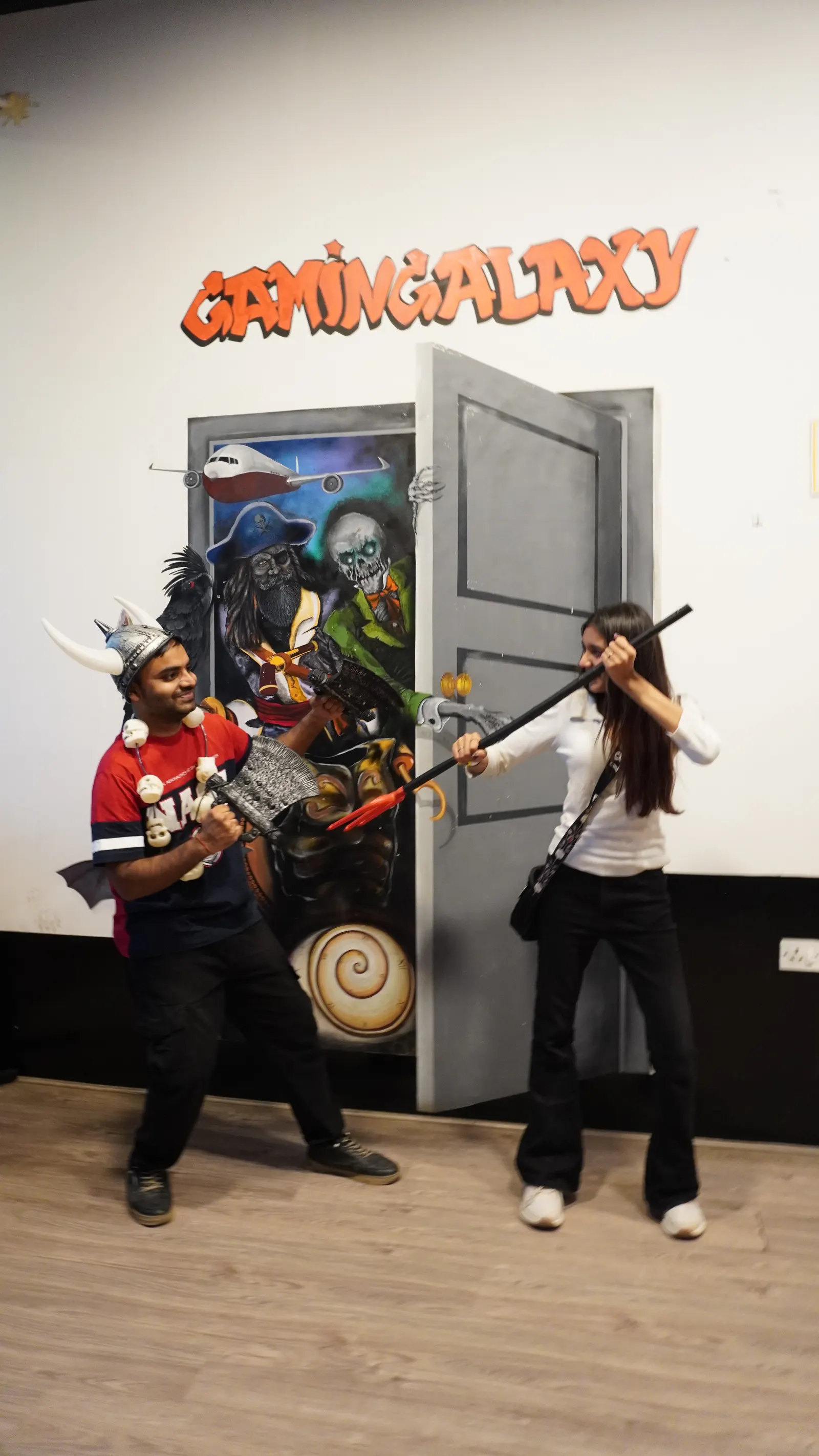 Guests enjoying action game props and indoor activities at Gamingalaxy Whitefield