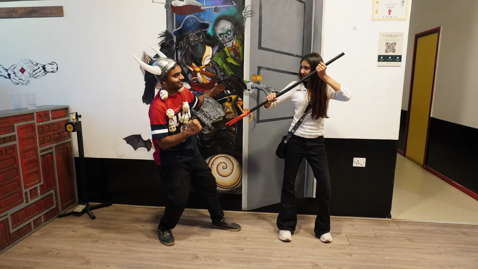 Guests enjoying action game props and indoor activities at Gamingalaxy Whitefield